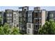 Exterior showcasing modern architecture, multiple balconies, and lush greenery around luxury apartments at 1301 Peachtree Ne St # 4L, Atlanta, GA 30309