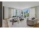 Bright living room features large windows, hardwood floors, and stylish furniture at 1301 Peachtree Ne St # 4L, Atlanta, GA 30309