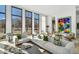 Bright living room with floor to ceiling windows, comfortable white sofas, and contemporary art at 1301 Peachtree Ne St # 4L, Atlanta, GA 30309