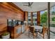 A modern outdoor kitchen with wood paneling, stainless steel appliances, and outdoor dining with city views at 1301 Peachtree Ne St # 4L, Atlanta, GA 30309