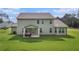 Charming two-story home showcasing a well-maintained lawn, covered patio and sunroom at 2 Whites Pond Rd, Moreland, GA 30259