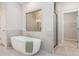 Bright bathroom with free-standing tub, glass enclosed shower and modern fixtures at 2 Whites Pond Rd, Moreland, GA 30259