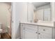 Bathroom featuring a single vanity, a mirror, a toilet, and a shower with a pink curtain at 2 Whites Pond Rd, Moreland, GA 30259