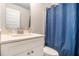 Bathroom featuring a single vanity, a mirror, a toilet, and a shower with a blue curtain at 2 Whites Pond Rd, Moreland, GA 30259