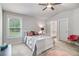 Bedroom featuring carpet, a ceiling fan, a window, and an ensuite bathroom at 2 Whites Pond Rd, Moreland, GA 30259