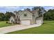 Spacious two-story home with a three-car garage, lush green lawn, and inviting curb appeal at 2 Whites Pond Rd, Moreland, GA 30259