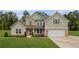 Charming two-story home with a mix of brick and siding, complemented by a well-manicured lawn at 2 Whites Pond Rd, Moreland, GA 30259