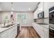 Bright kitchen featuring white cabinets, stainless steel appliances, and hardwood floors at 2 Whites Pond Rd, Moreland, GA 30259