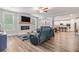 Open-concept living room featuring hardwood floors, a fireplace, and seamless access to the kitchen at 2 Whites Pond Rd, Moreland, GA 30259