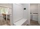 Mud room with built-in bench and storage adjacent to modern laundry area at 2 Whites Pond Rd, Moreland, GA 30259