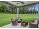 Covered patio featuring outdoor seating and views of the backyard and green forest at 2 Whites Pond Rd, Moreland, GA 30259