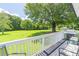 Spacious back deck with chairs and a grill, overlooking a green lawn and trees at 3152 H D Atha Rd, Covington, GA 30014