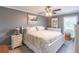 Comfortable bedroom with queen bed, ceiling fan, neutral walls, and bright, windowed natural light at 3152 H D Atha Rd, Covington, GA 30014