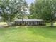 Charming brick home with lush green lawn, mature trees, and covered outdoor space to enjoy the outdoors at 3152 H D Atha Rd, Covington, GA 30014