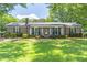 Charming brick ranch home with a metal roof and manicured front lawn at 3152 H D Atha Rd, Covington, GA 30014
