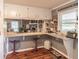 Eat-in kitchen featuring a countertop bar, white cabinets, and view of stone fireplace in adjacent room at 3152 H D Atha Rd, Covington, GA 30014