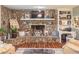 Cozy living room featuring a stone fireplace and built-in shelving at 3152 H D Atha Rd, Covington, GA 30014