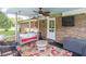 Relaxing screened porch with a swing, ceiling fan, and comfortable seating at 3152 H D Atha Rd, Covington, GA 30014