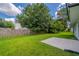 Large, well-maintained backyard with lawn, trees, and privacy fence at 5916 Farmbrook Ln, Rex, GA 30273