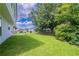 View of the spacious backyard with mature trees and a privacy fence at 5916 Farmbrook Ln, Rex, GA 30273