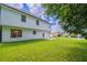 Lush green backyard with a two-story home and well-manicured lawn at 5916 Farmbrook Ln, Rex, GA 30273