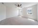 Bedroom with ceiling fan, carpeted flooring, and two bright windows at 5916 Farmbrook Ln, Rex, GA 30273
