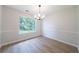 Dining room features modern lighting, wood-look flooring and a large window at 5916 Farmbrook Ln, Rex, GA 30273