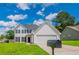 Charming two-story home featuring a well-manicured lawn and classic white siding at 5916 Farmbrook Ln, Rex, GA 30273