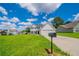 Well-maintained home with lush green lawn and a traditional mailbox, showcasing curb appeal at 5916 Farmbrook Ln, Rex, GA 30273