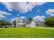 Classic two-story home with a green lawn, showcasing its welcoming curb appeal at 5916 Farmbrook Ln, Rex, GA 30273