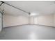 Spacious garage with epoxy flooring, overhead door, and side entry door at 5916 Farmbrook Ln, Rex, GA 30273