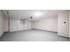 Spacious two-car garage with epoxy flooring, garage door and opener at 5916 Farmbrook Ln, Rex, GA 30273