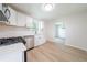Updated kitchen featuring stainless steel appliances and white cabinets with backyard view at 5916 Farmbrook Ln, Rex, GA 30273