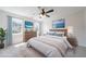 Nicely staged primary bedroom with bed, dressers, and bright windows at 5916 Farmbrook Ln, Rex, GA 30273