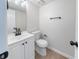 This powder room features a toilet, vanity, and modern fixtures at 5916 Farmbrook Ln, Rex, GA 30273