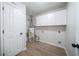 The utility room includes water heater, storage, and wood-look flooring at 5916 Farmbrook Ln, Rex, GA 30273