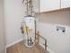 A water heater stands against a wall in a utility area at 5916 Farmbrook Ln, Rex, GA 30273