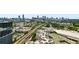 A vibrant cityscape view of Atlanta skyline with lush greenery, trains, and residential buildings under a clear sky at 788 W Marietta Nw St # 308, Atlanta, GA 30318