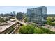 A stunning aerial view showcases a modern glass condo building with Atlanta's skyline and surrounding greenery in the background at 788 W Marietta Nw St # 308, Atlanta, GA 30318