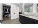 Contemporary bathroom boasts an illuminated mirror, sleek vanity, and an adjacent walk-in closet at 788 W Marietta Nw St # 308, Atlanta, GA 30318