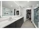 Sleek bathroom featuring a double vanity, large mirror, and a walk-in shower with glass door at 788 W Marietta Nw St # 308, Atlanta, GA 30318