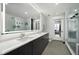 Modern bathroom with a double vanity, a large mirror, and a glass-enclosed shower at 788 W Marietta Nw St # 308, Atlanta, GA 30318