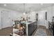 Island with seating, white counters and view of stainless steel appliances and open floor plan at 788 W Marietta Nw St # 308, Atlanta, GA 30318