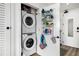 Convenient laundry closet includes a stacked washer and dryer, with cleaning supplies storage at 788 W Marietta Nw St # 308, Atlanta, GA 30318