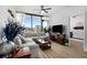 Living room with comfortable furniture, large windows, and view of a door to a bedroom at 788 W Marietta Nw St # 308, Atlanta, GA 30318