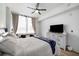 Comfortable main bedroom featuring a ceiling fan, dresser with TV, and large window at 788 W Marietta Nw St # 308, Atlanta, GA 30318
