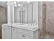 Elegant bathroom featuring double sinks, marble countertops, and a tiled shower at 872 Briarcliff Ne Rd # B2, Atlanta, GA 30306