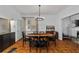 Bright dining room with hardwood floors, modern chandelier, and view into the entryway at 872 Briarcliff Ne Rd # B2, Atlanta, GA 30306