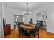 Elegant dining room with hardwood floors, modern chandelier, and view into living room and kitchen at 872 Briarcliff Ne Rd # B2, Atlanta, GA 30306