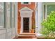Classic brick townhome entrance with black door, brick steps, white trim, and charming potted plants at 872 Briarcliff Ne Rd # B2, Atlanta, GA 30306